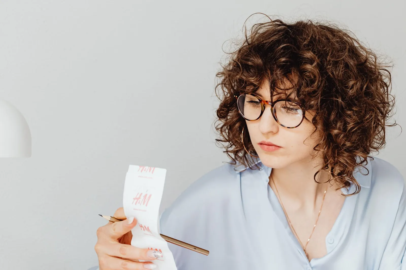 Woman reviewing receipts while working out her budget