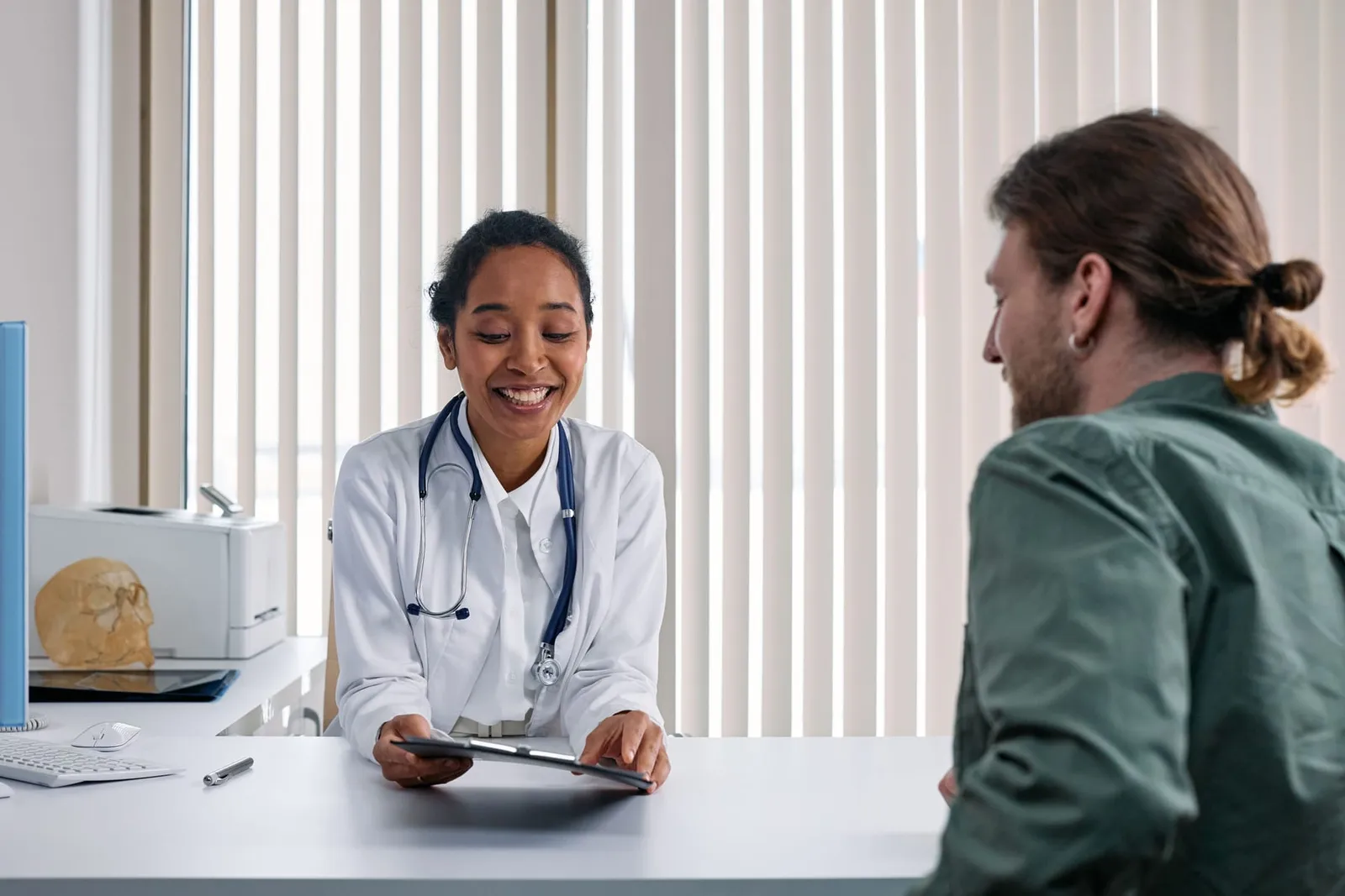 Doctor smiling while talking with a patient during a checkup